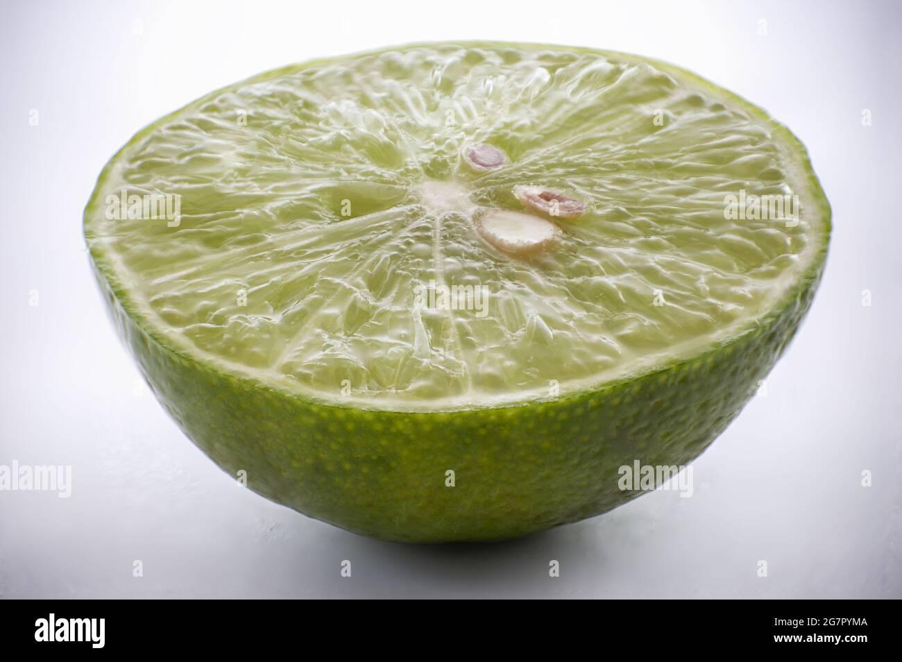 Closeup shot of sliced lime isolated on white background Stock Photo ...
