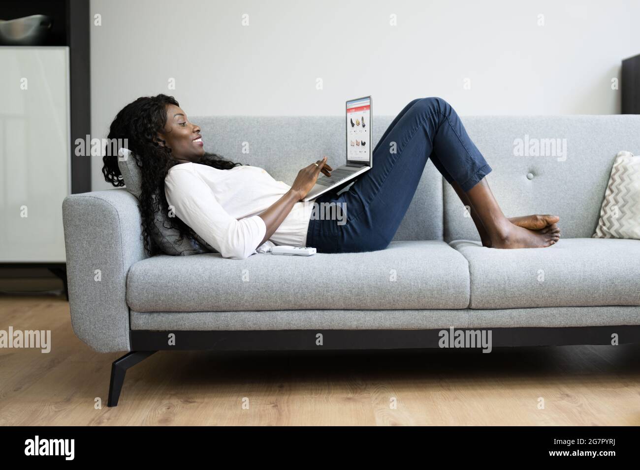 Relaxed Woman Online Shopping On Couch Using Laptop Stock Photo Alamy