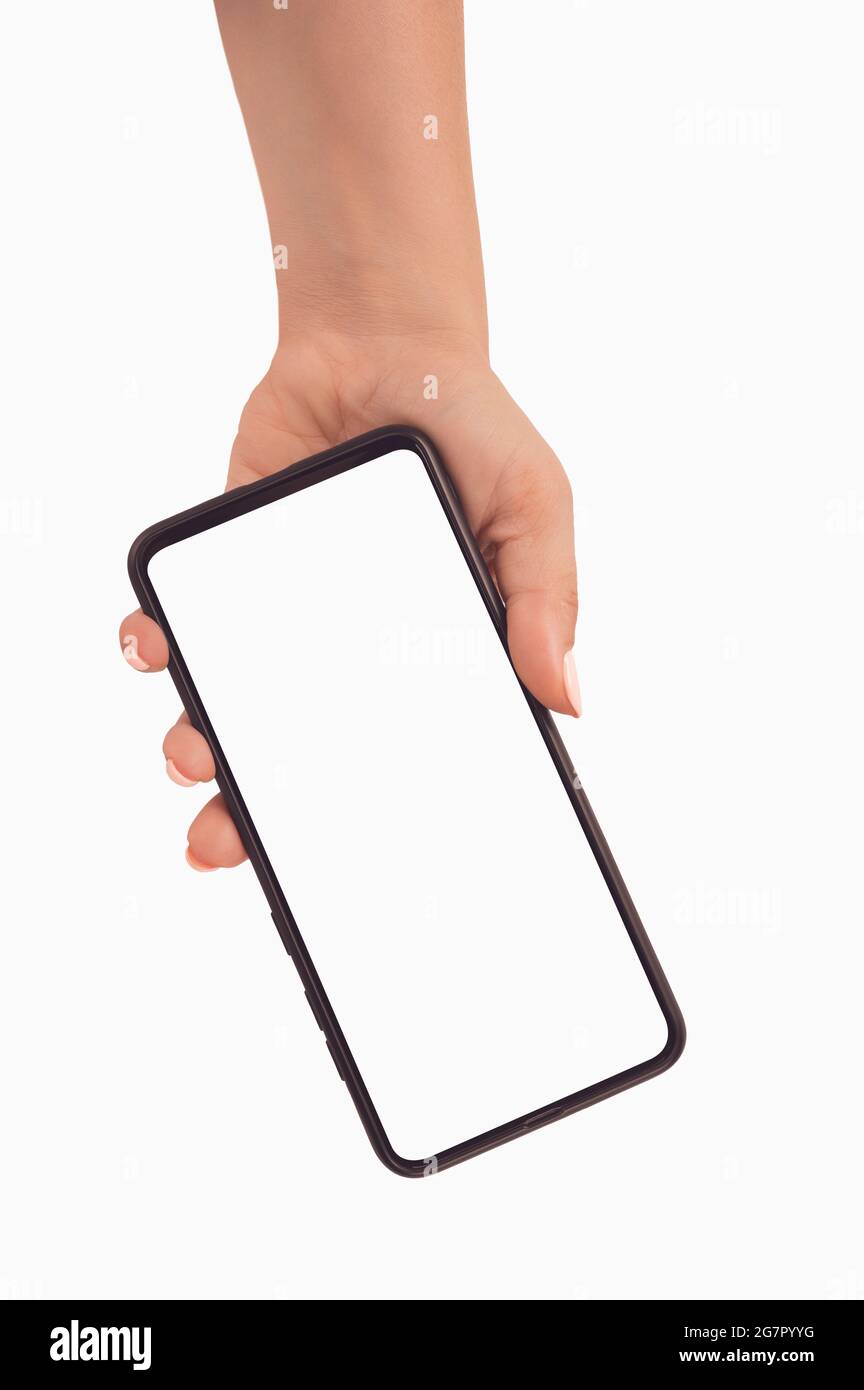 Female hand holding black cellphone with white screen at isolated background from top to bottom. Person holding smartphone with blank white screen. Mo Stock Photo