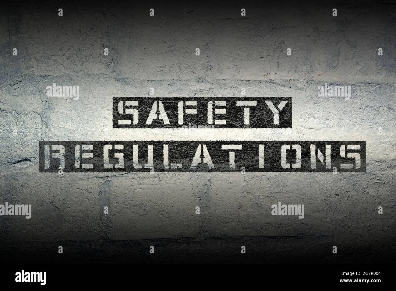 safety regulations stencil print on the grunge white brick wall Stock