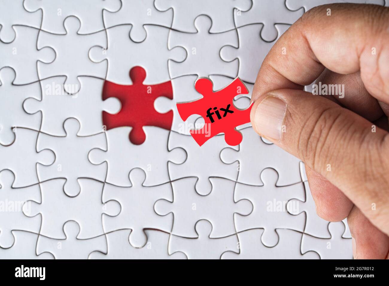 Business concept. Jigsaw puzzle with text fix on red background. Selective focus point Stock Photo