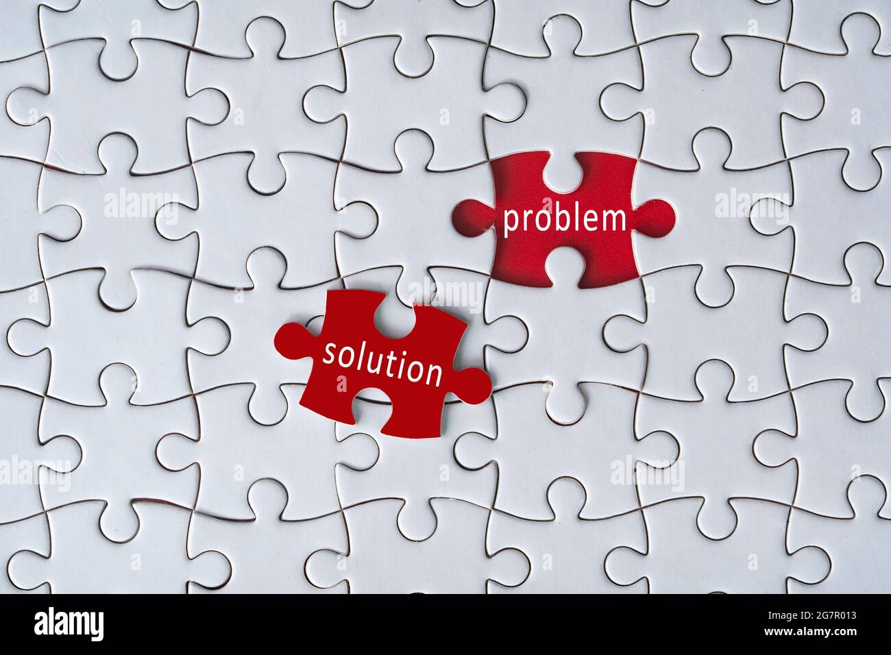 Business concept. Jigsaw puzzle with text problem and solution on red background. Selective focus point Stock Photo