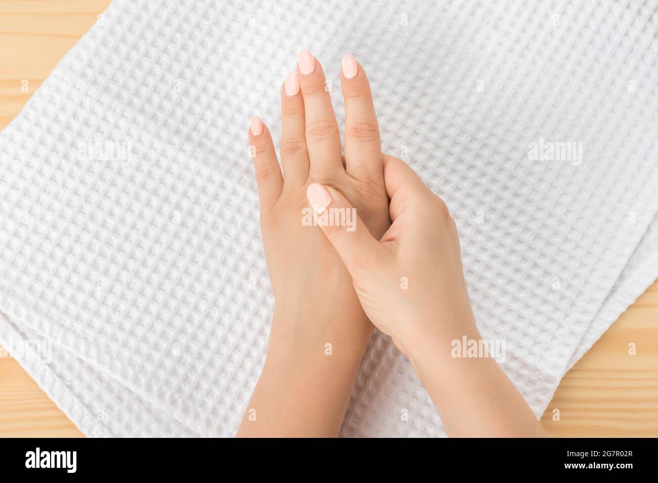 Self hand massage by caucasian young woman. Fingers and hand joint health. Self massage. Healthy Massage. Closeup hand of person massage her hand from Stock Photo