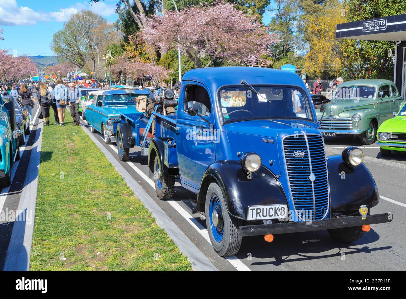 A 1948 Ford Fordson truck with other vintage vehicles at an outdoor classic car show Stock Photo