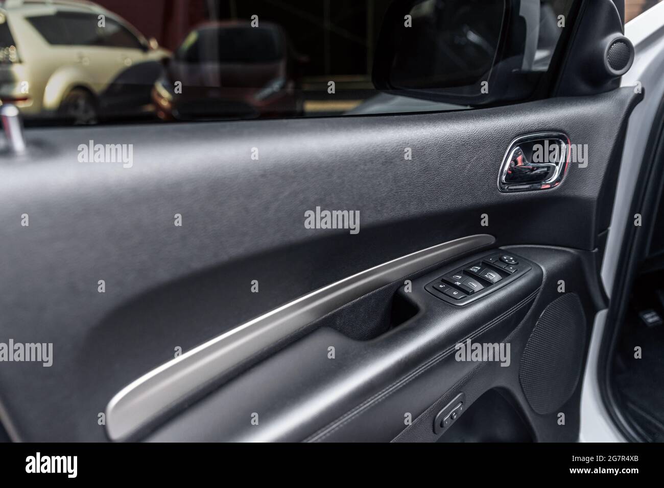 Mirror control knob and window control panel in a modern car. Automatic