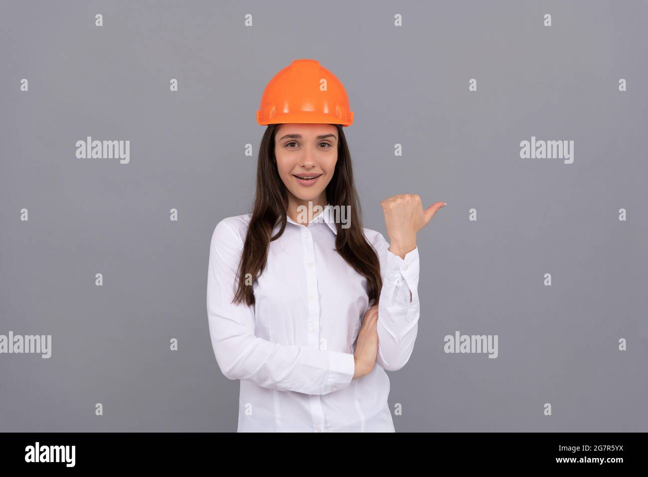cheerful woman worker directing thumb up. quality inspector. female construction worker. Stock Photo