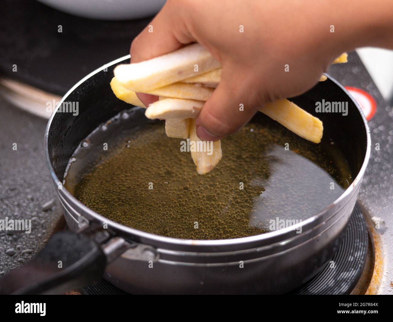 Close up of Frying french fries in the fryer in hot oil on the electric