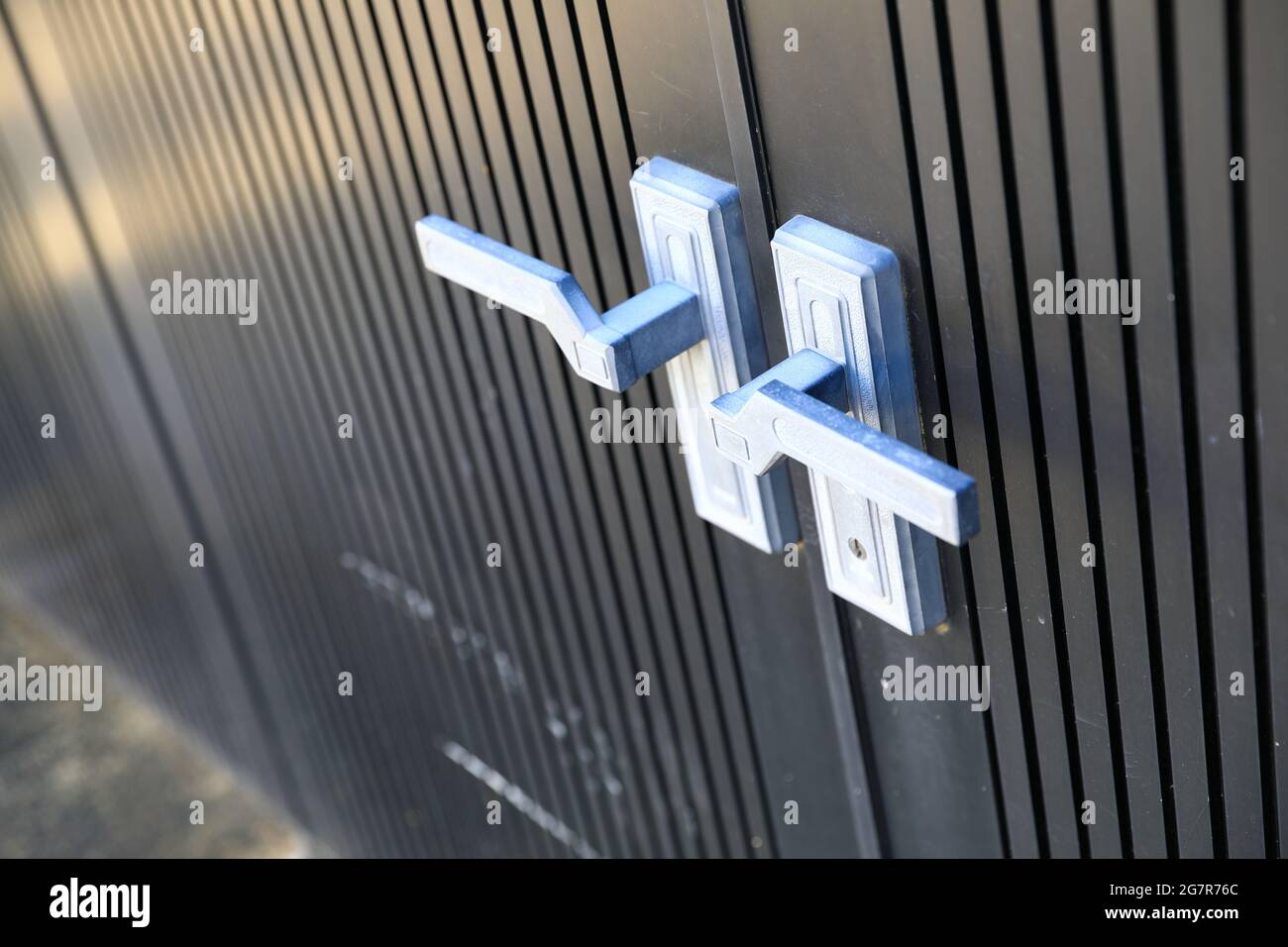 Exterior door handle and Security lock on black door, Modern chrome