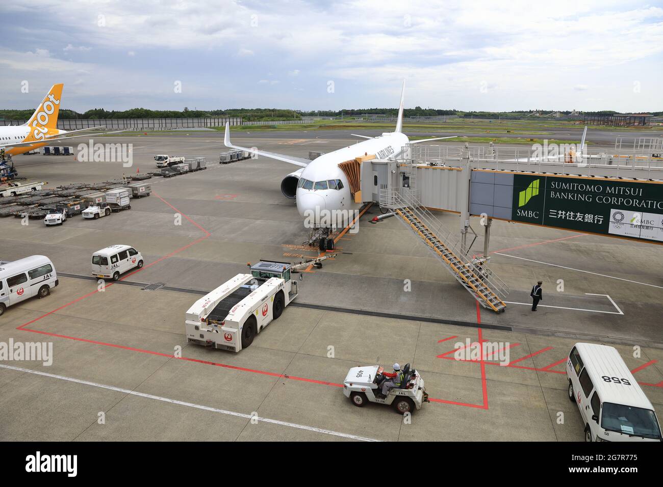 NARITA, JAPAN - MAY 2018 : Airplane Tugs, and baggage tug operate in ground handling services at narita Airport, Japan. Stock Photo