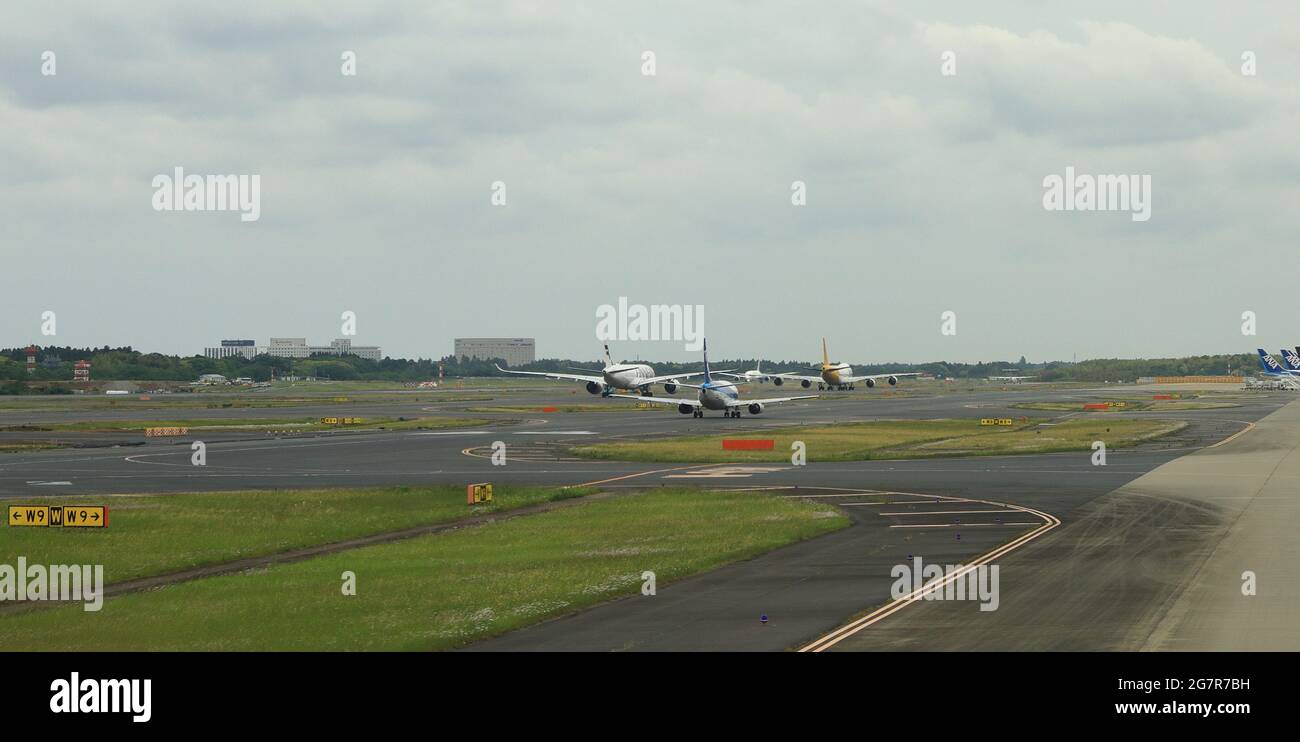 NARITA, JAPAN - May, 2018 : Narita International Airport view, Airplane taxi in taxiway, on queue prepare to take-off. Stock Photo