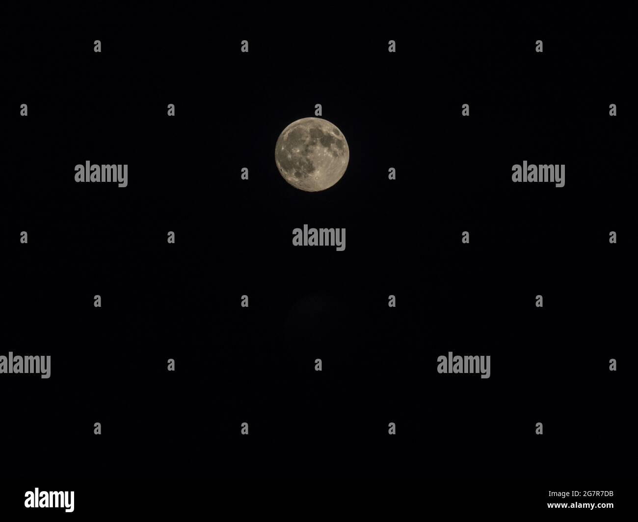 Closeup of a full moon isolated on a dark evening sky Stock Photo - Alamy