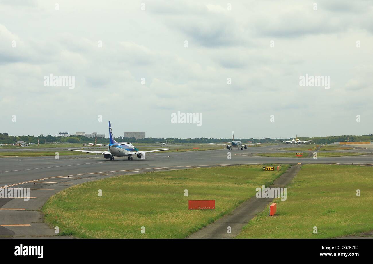NARITA, JAPAN - May, 2018 : Narita International Airport view, Airplane taxi in taxiway, on queue prepare to take-off. Stock Photo