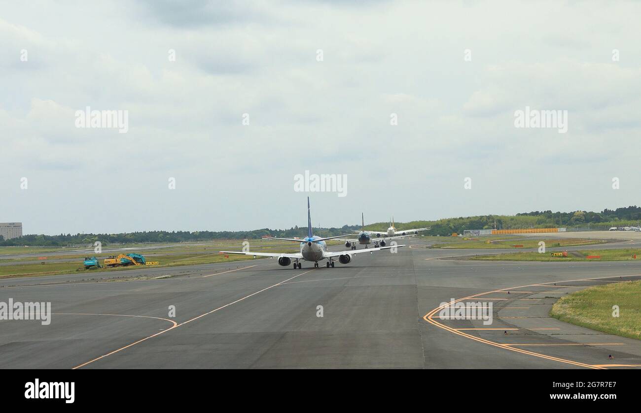 NARITA, JAPAN - May, 2018 : Narita International Airport view, Airplane taxi in taxiway, on queue prepare to take-off. Stock Photo