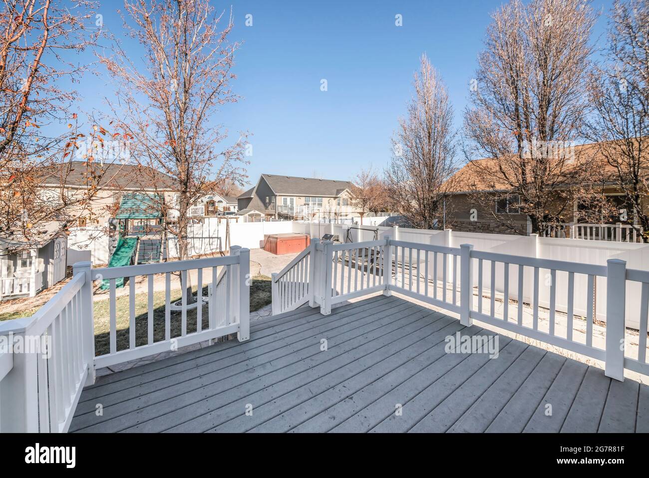 Deck of a house with a view of a playground in the backyard Stock Photo