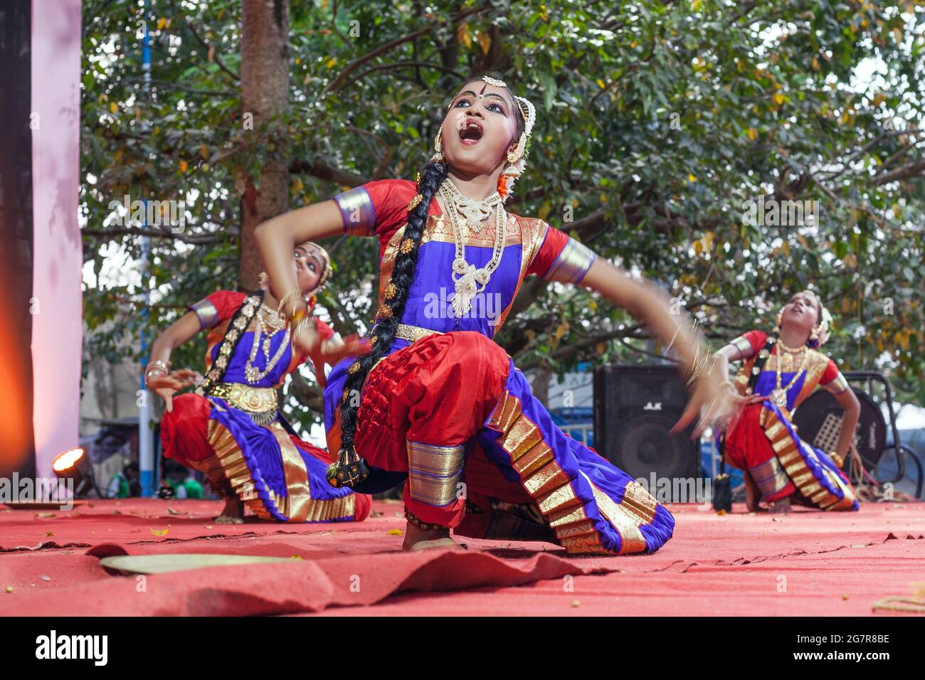Young female Indian classical dancers in colourful costumes perform on stage, Fort Kochi (Cochin), Kerala, India Stock Photo