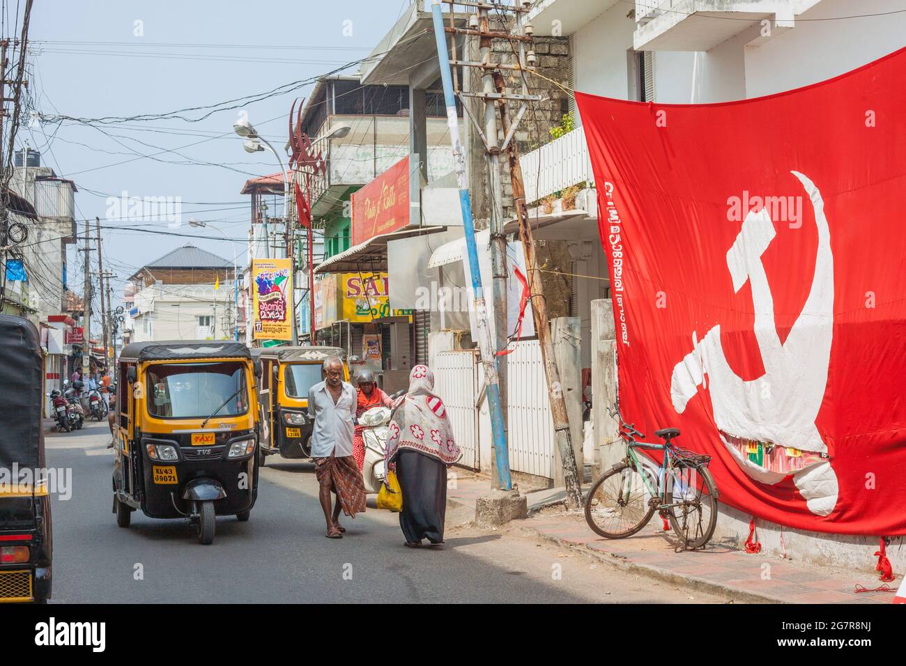 Huge hammer & sickle flag representing the CPI(M) Communist Party of Kerala hanging on street in Fort Kochi (Cochin), Kerala, India Stock Photo