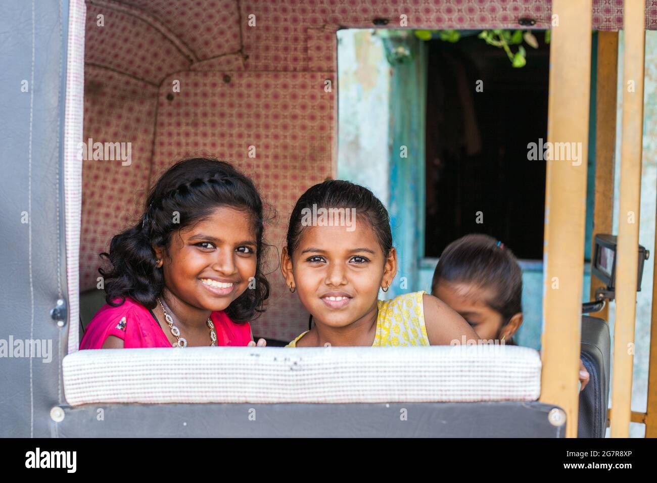 Two pretty young Indian seated in auto rickshaw pose for photo, Fort Kochi (cochin), Kerala, India Stock Photo
