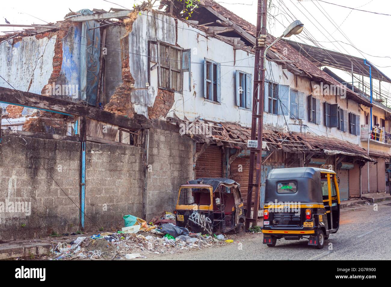 Ruined auto rickshaw outside warehouses ready for destruction, Fort Kochi (cochin), Kerala, India Stock Photo