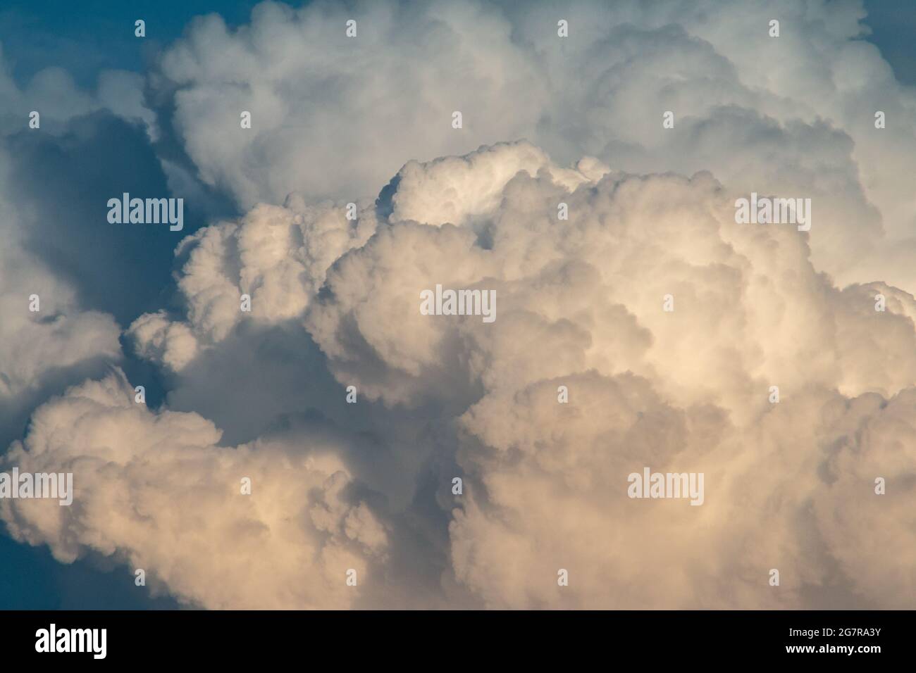 fluffy stormy clouds in the sunset sky Stock Photo