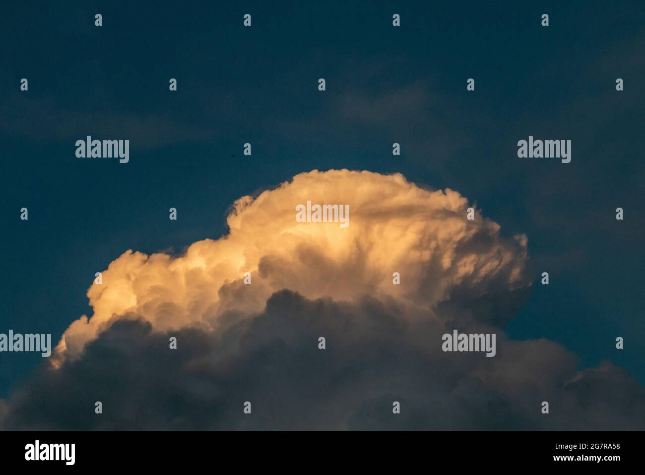 fluffy stormy clouds in the sunset sky Stock Photo