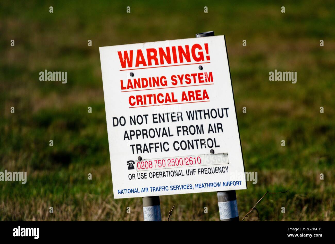 Instrument Landing System (ILS) area at London Heathrow Airport, UK. Sign, warning. Pilot navigation approach aid guiding aircraft in to land Stock Photo