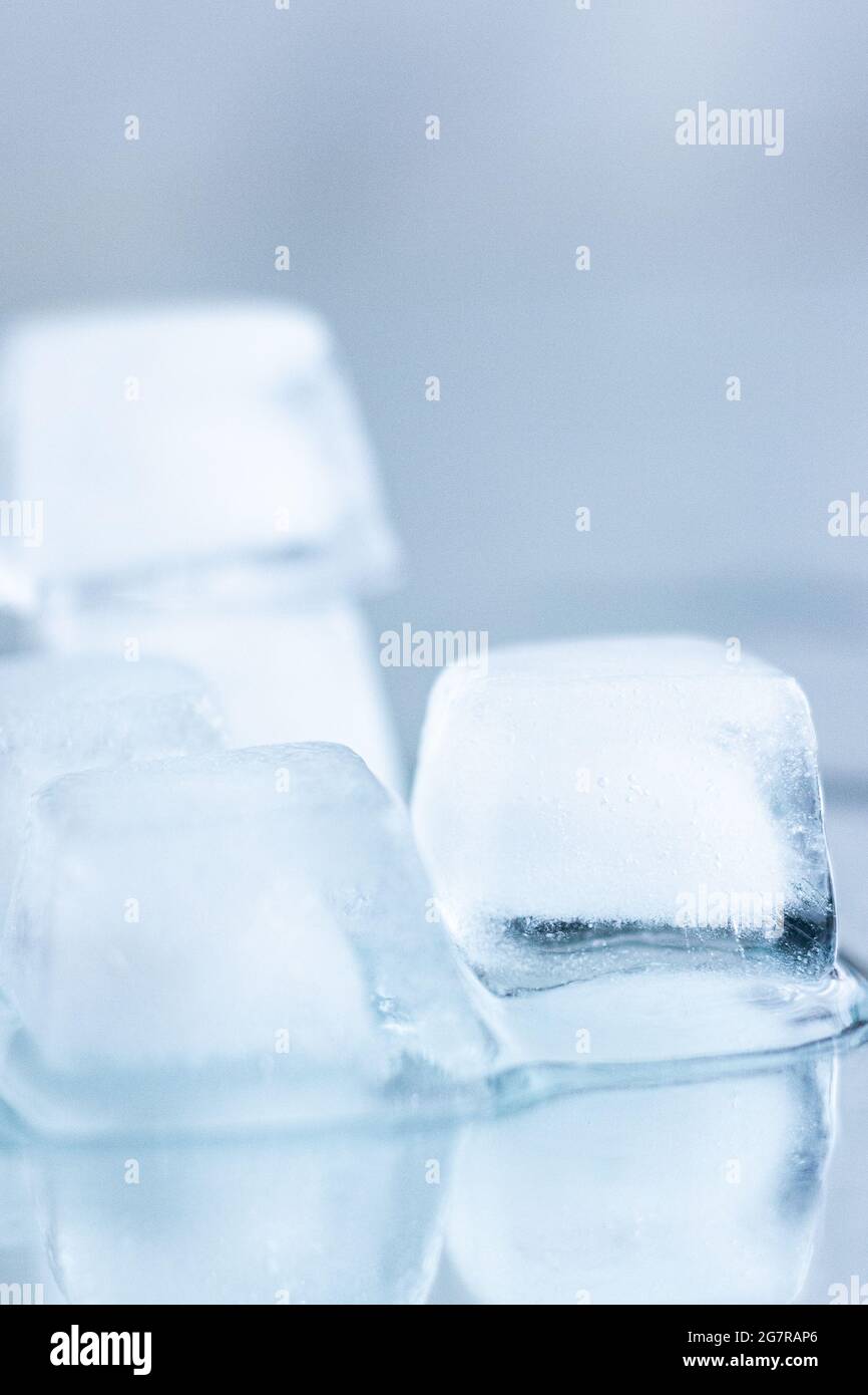 Stack of ice cubes with reflection; ice cubes melting; refreshing ...