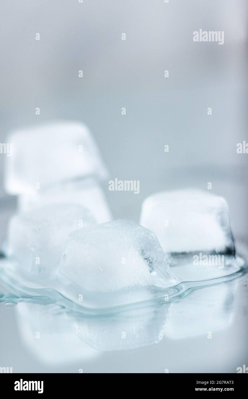 Stack of ice cubes with reflection; ice cubes melting; refreshing drinks; cooling water; summer refreshment Stock Photo