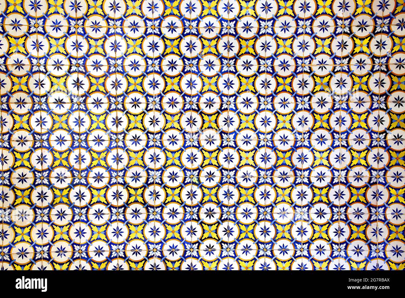 Traditional glazed blue, yellow and white ceramic tiles or azulejos which cover many buildings in Lisbon, Portugal. These Portugese tiles have many di Stock Photo