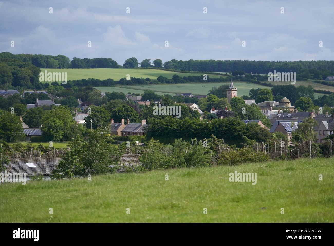 View across fields of the town of Greenlaw in the Scottish Borders.The Town Hall a prominent landmark. Stock Photo