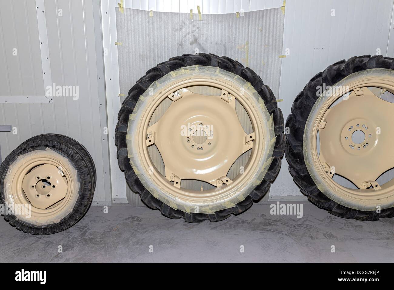 Freshly painted rims in a light color from a farm tractor standing in