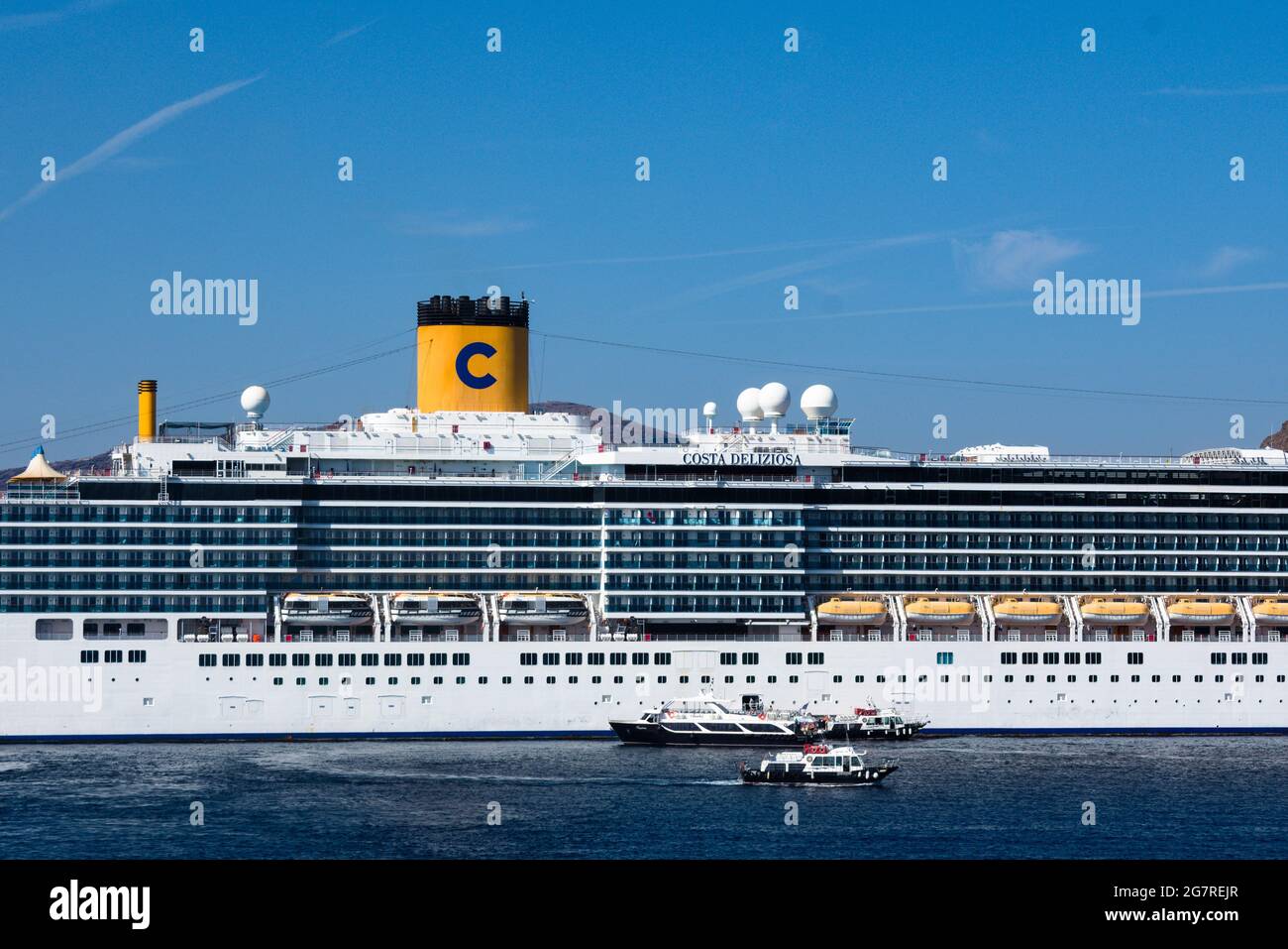Santorini island - Greece - October 3 2018 : Holiday cruise ship at anchor. Close up view of of boat. Blue sky and copy space. Stock Photo