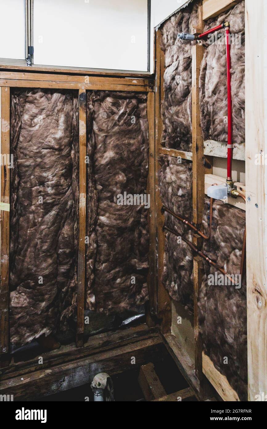 shower renovation with shower walls interior exposed and copper pipes