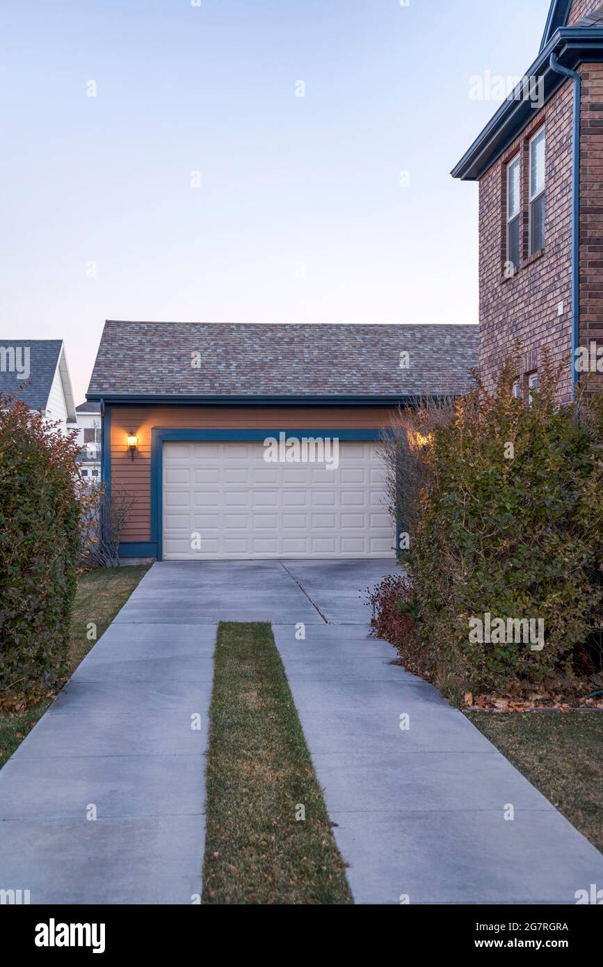 Detached garage exterior at the back of a house with brown color tones  Stock Photo - Alamy, image size:867x1390