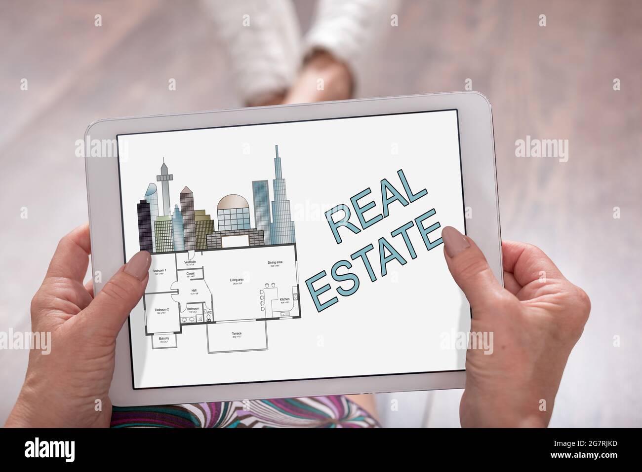 Real estate concept shown on a tablet held by a woman Stock Photo