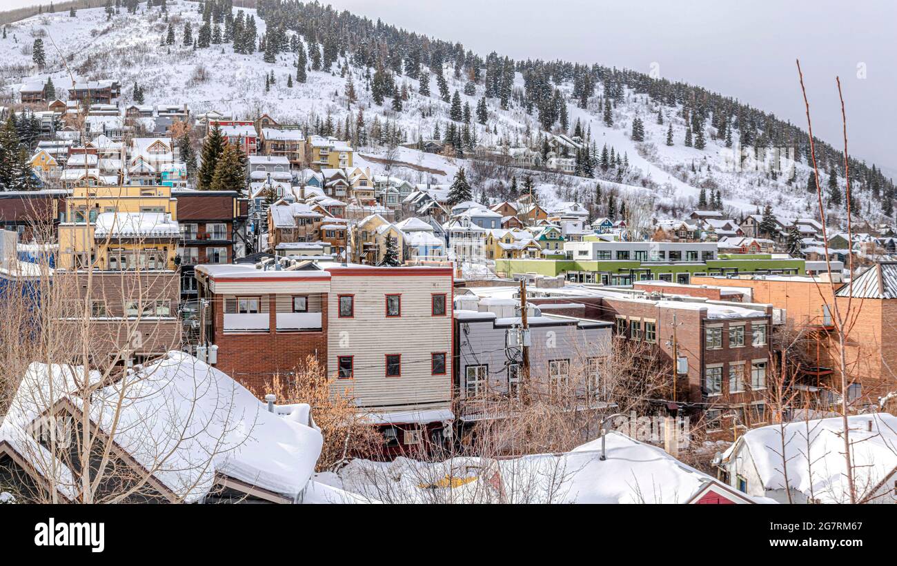 Pano Colorful houses and buildings on a snow-covered hill at Park City in Utah Stock Photo