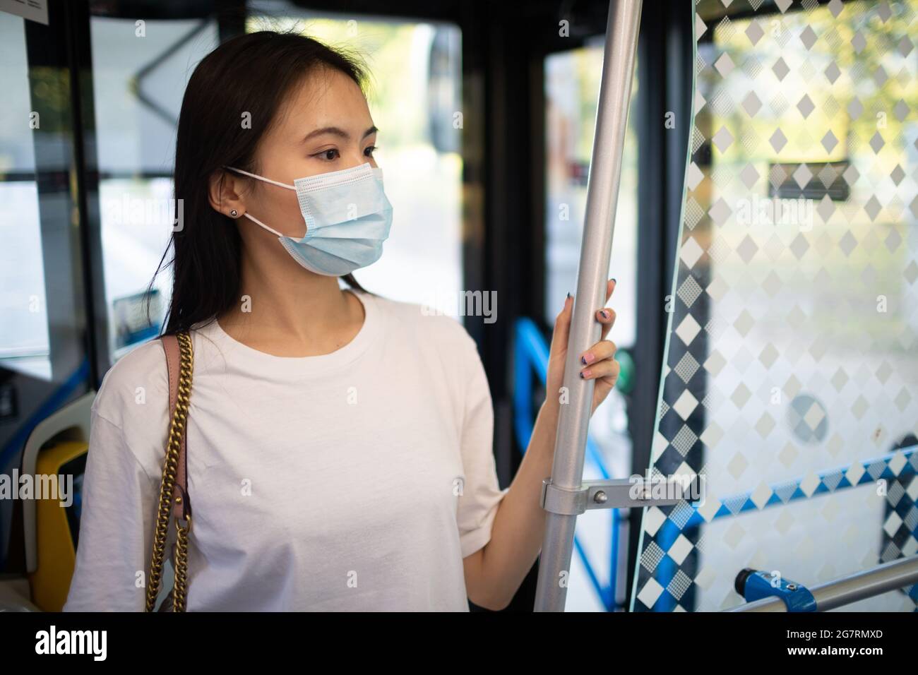 Asian Korean or Japanese Woman take a ride stand in public transport