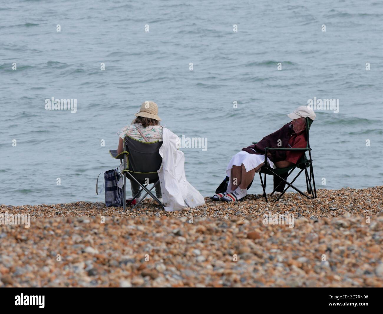 Older couple relaxing on the beach Stock Photo - Alamy
