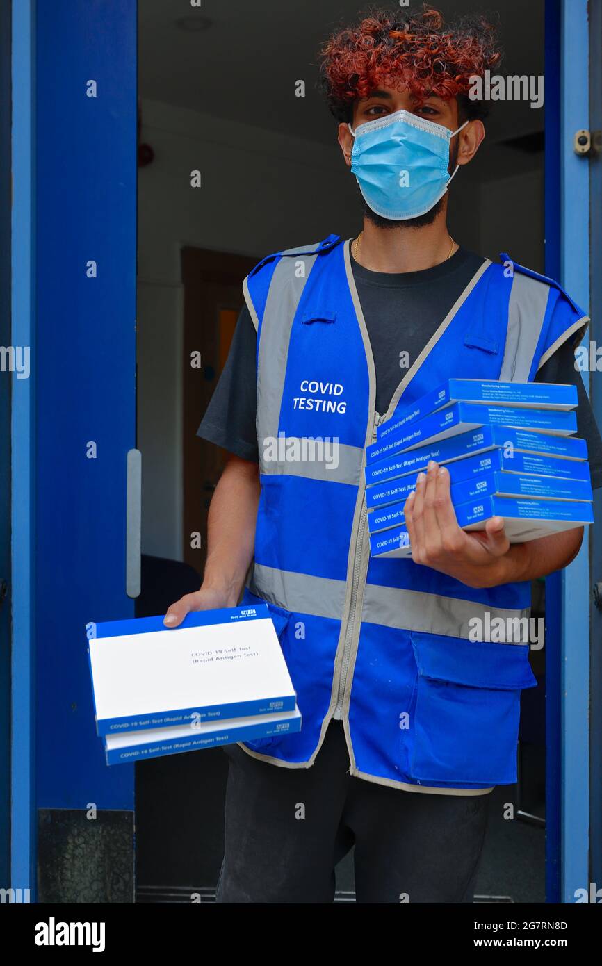 Londom (UK), 14 July 2021: An NHS support worker hands out covid self testing kits to members of the public on the streets of central London Stock Photo