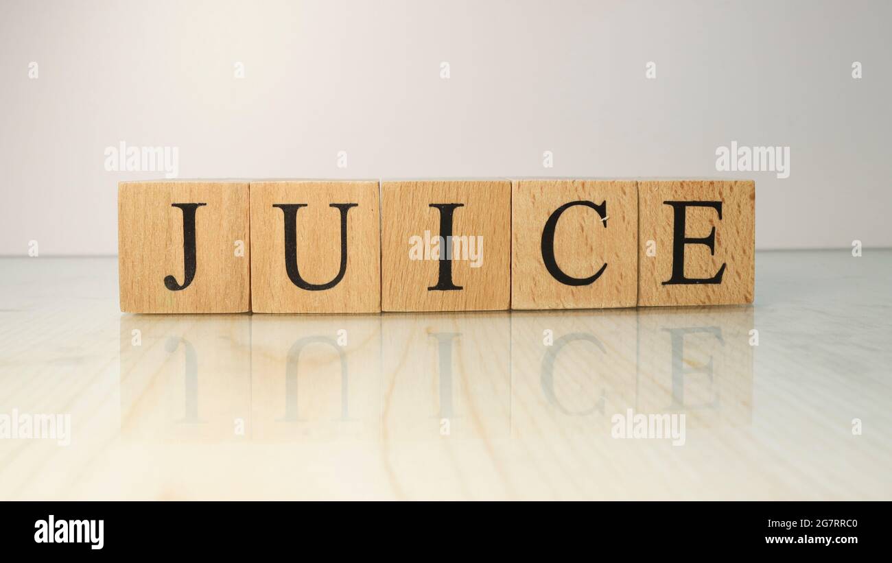 The word Juice was created from wooden letter cubes. Drinks and flavors. close up Stock Photo