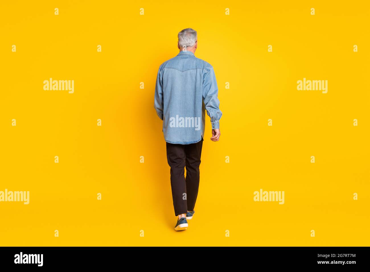 Full length back photo of trend grandpa go wear jacket pants shoes isolated on yellow color background Stock Photo