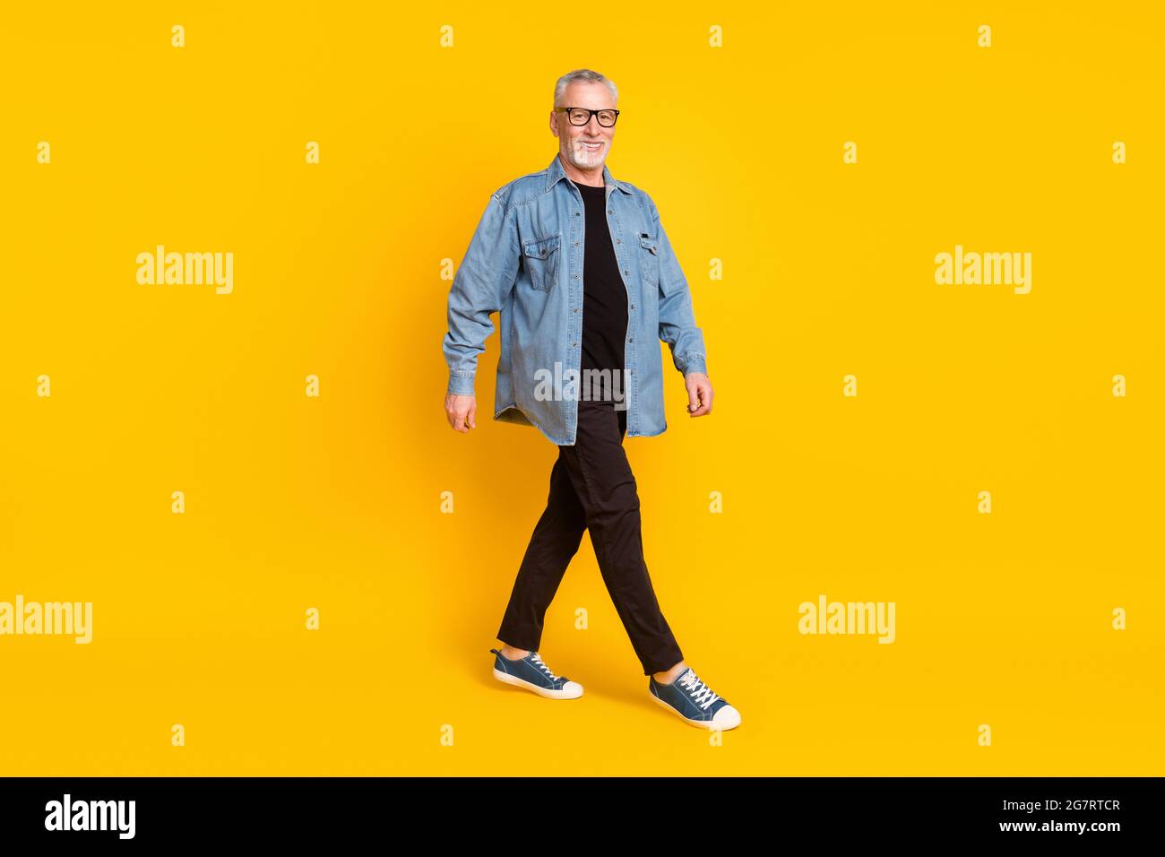 Full body profile photo of funny grandpa go wear eyewear jacket pants isolated on yellow background Stock Photo