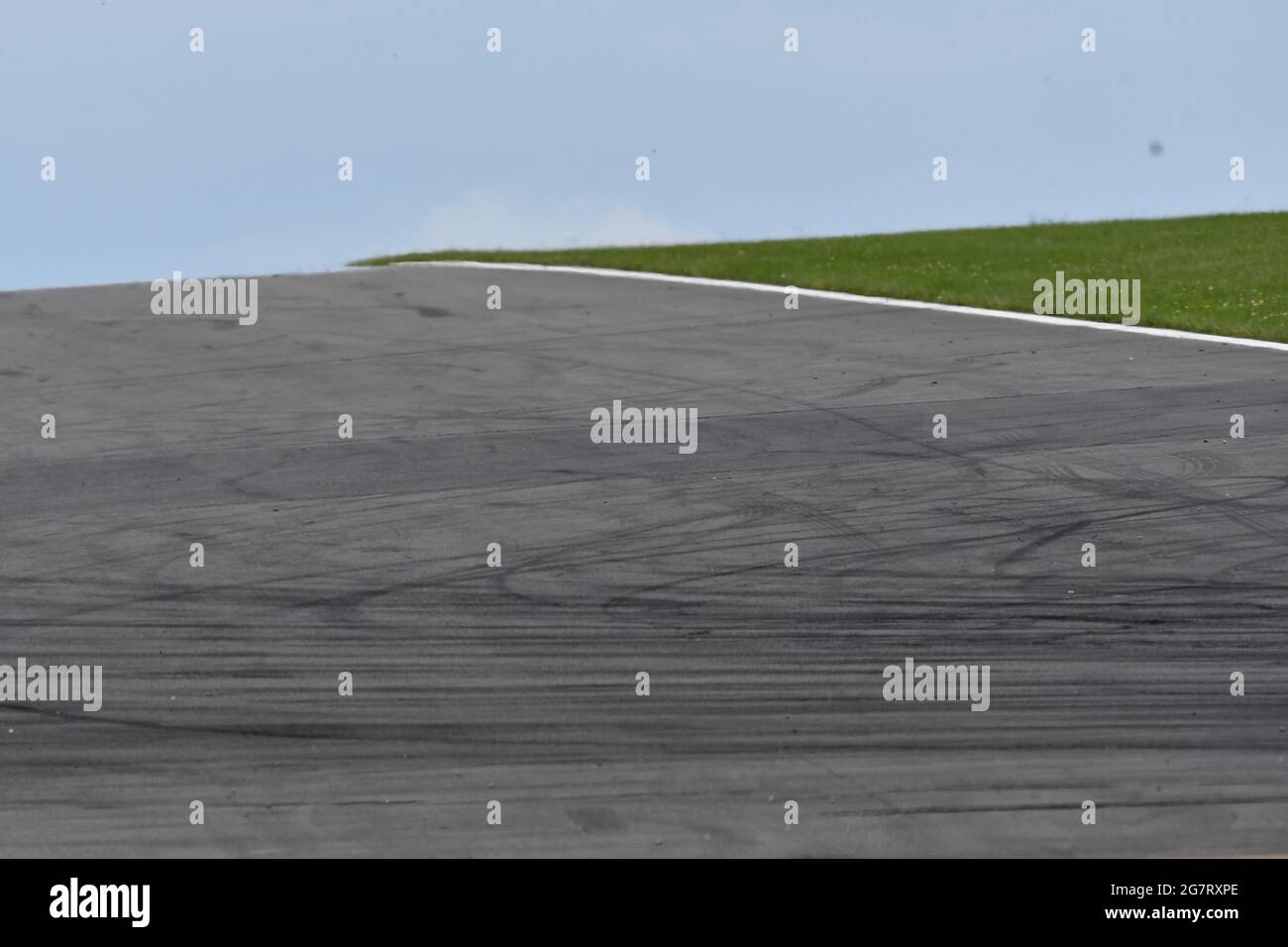 A section of a race track going up a hill showing tyre skid marks Stock Photo