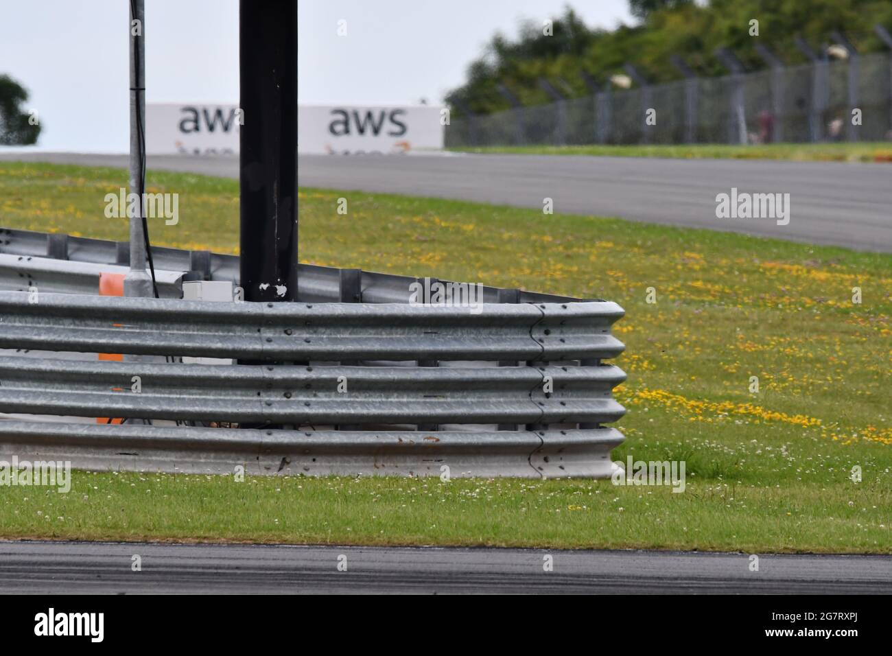 A corner of a racing car track with its protective barrier and security fencing Stock Photo