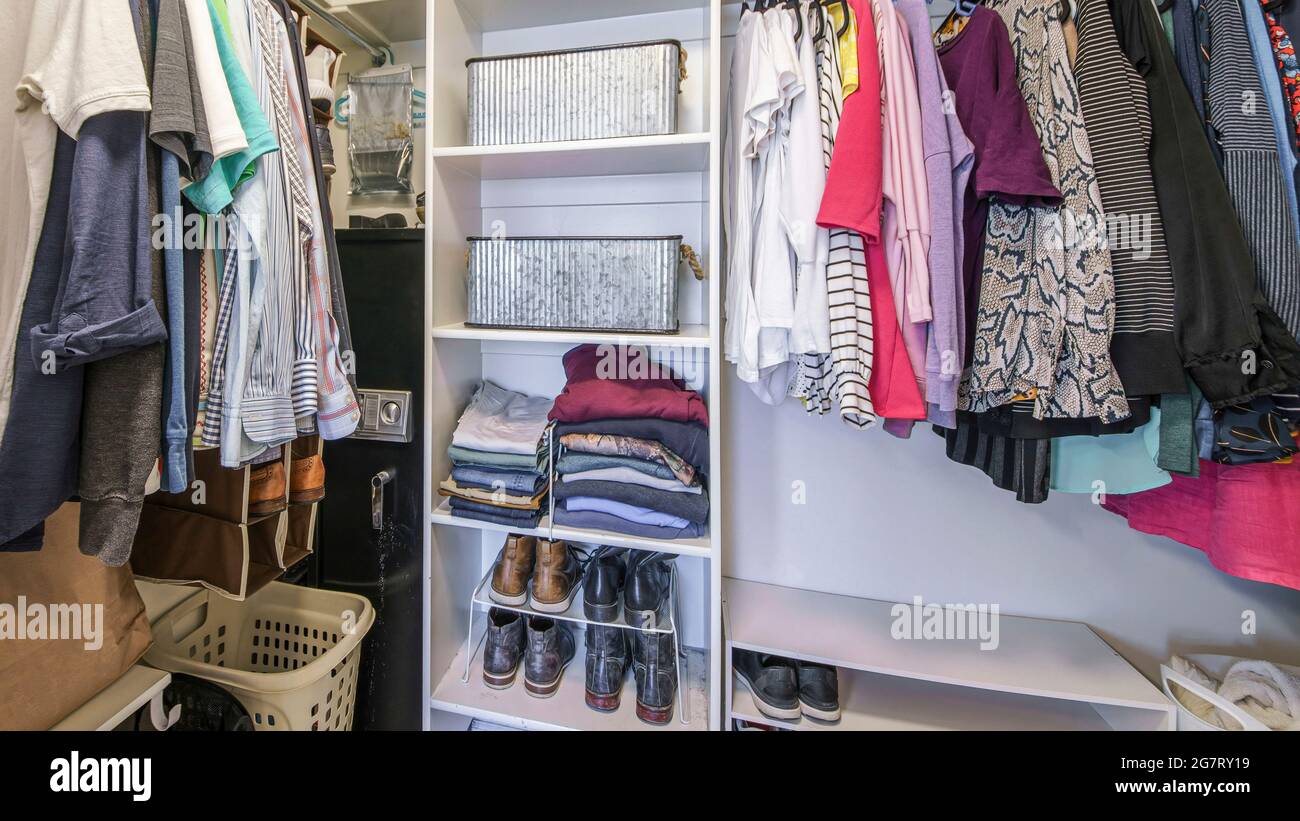 Pano Full small walk in closet with baskets and vault inside Stock Photo
