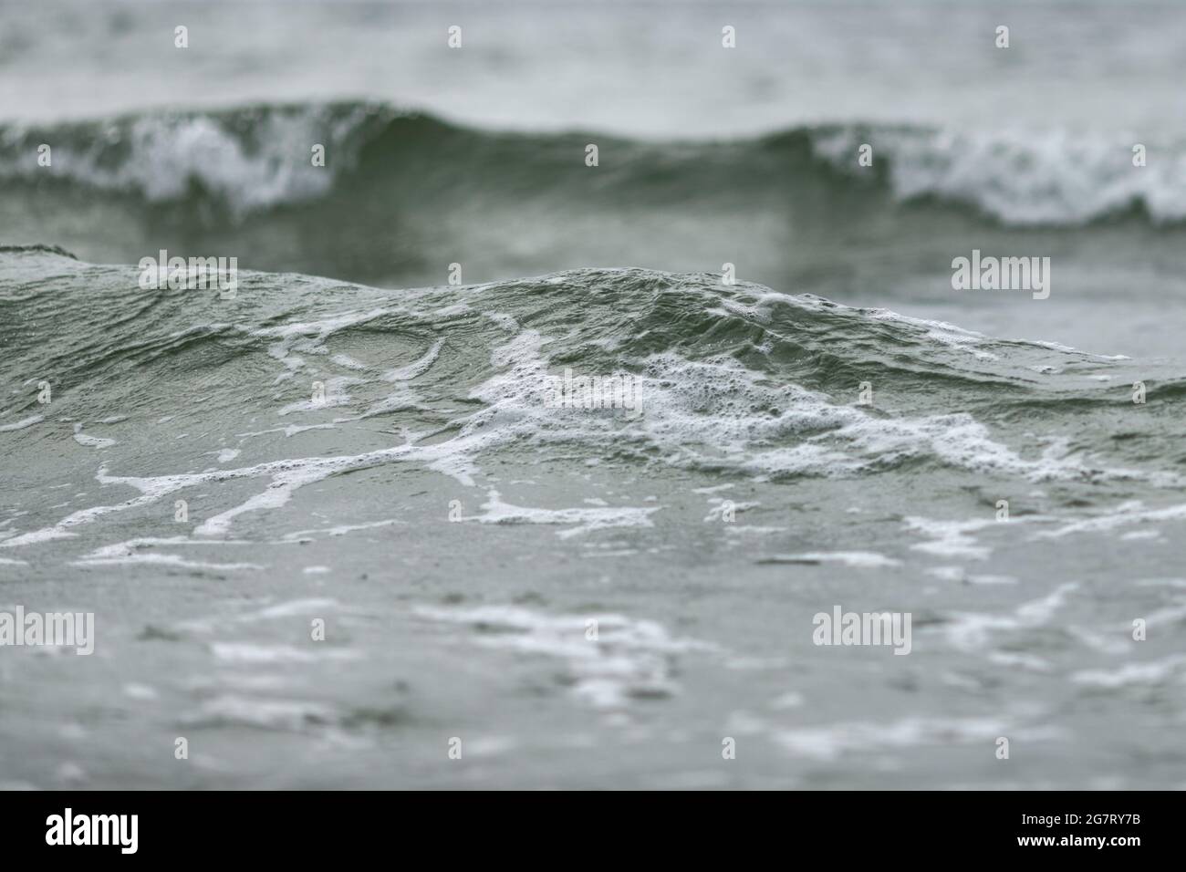 Close up of sea wave in pleasant blue and green tones low angle view water background. Summer holiday concept. Stock Photo