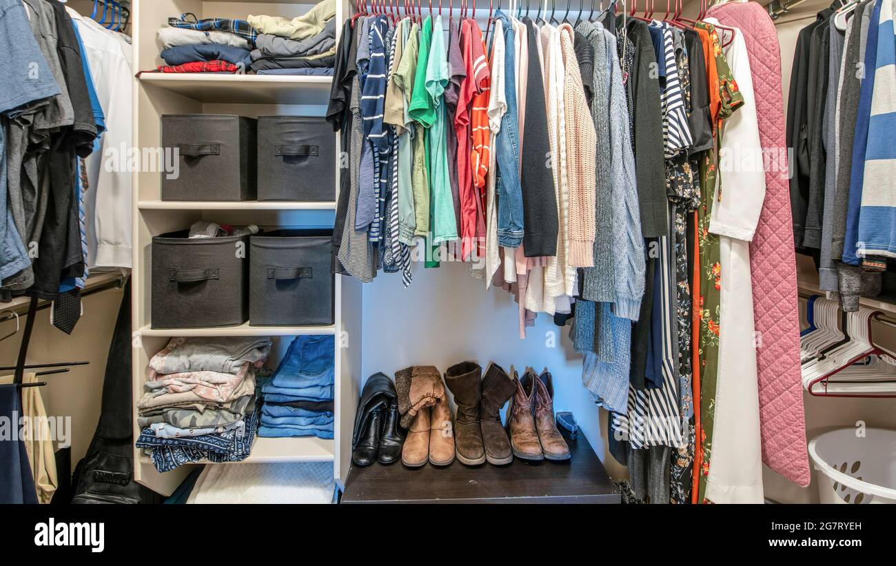 Pano Organized small walk in wardrobe with clothes and linen storage boxes  Stock Photo - Alamy