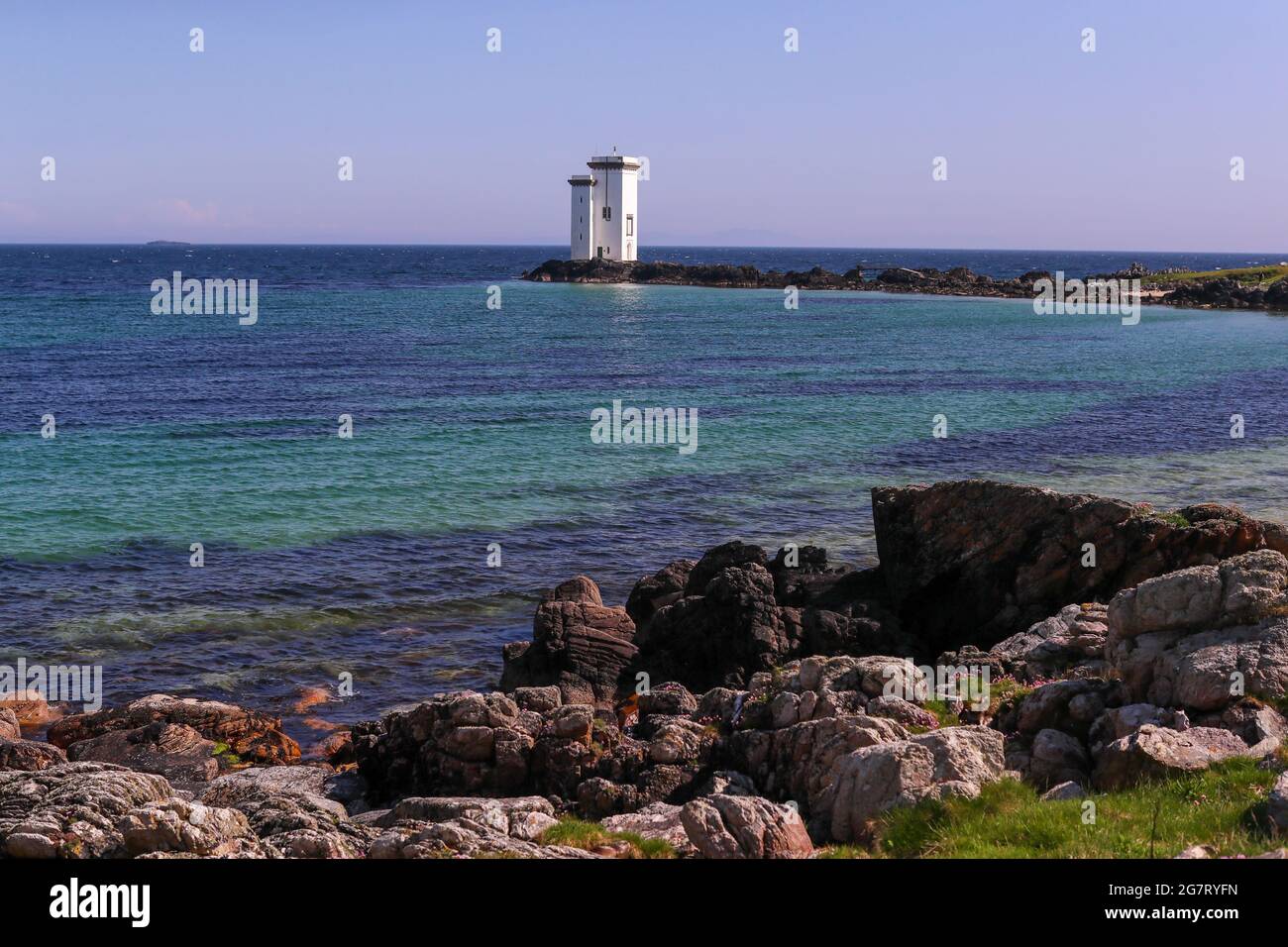 Carraig Fhada Lighthouse on the Isle of Islay off the west coast of Scotland.  The small island is famous for it many whisky distilleries. Stock Photo