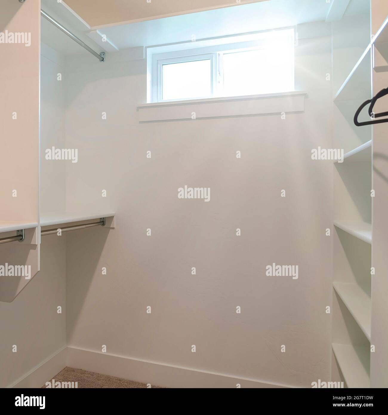 Square frame Walk in closet of a new home with empty wall shelves and ...