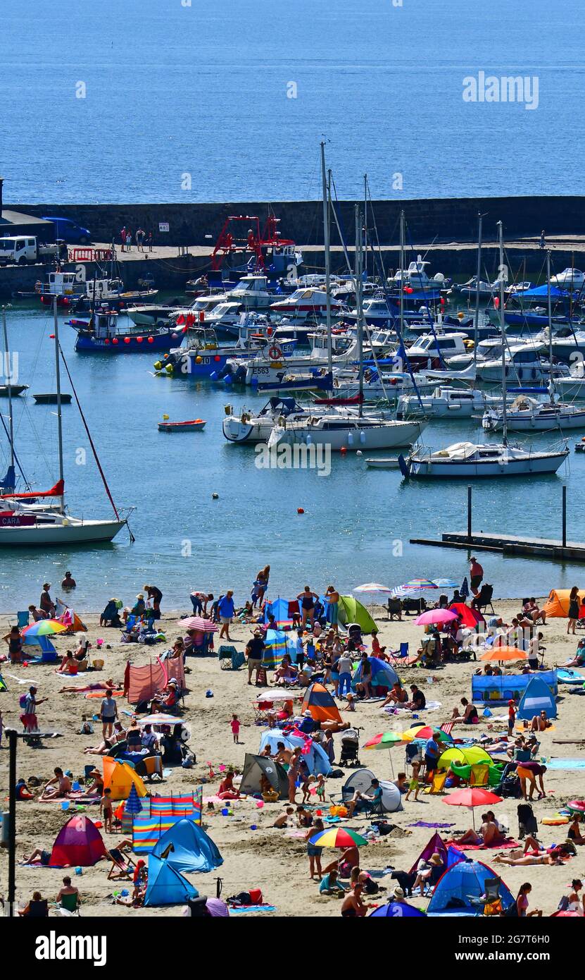 Lyme Regis, UK. 16th July, 2021. UK Weather.Lyme Regis beach is packed with holiday makers on one of the hottest days so far. Picture Credit: Robert Timoney/Alamy Live News Stock Photo