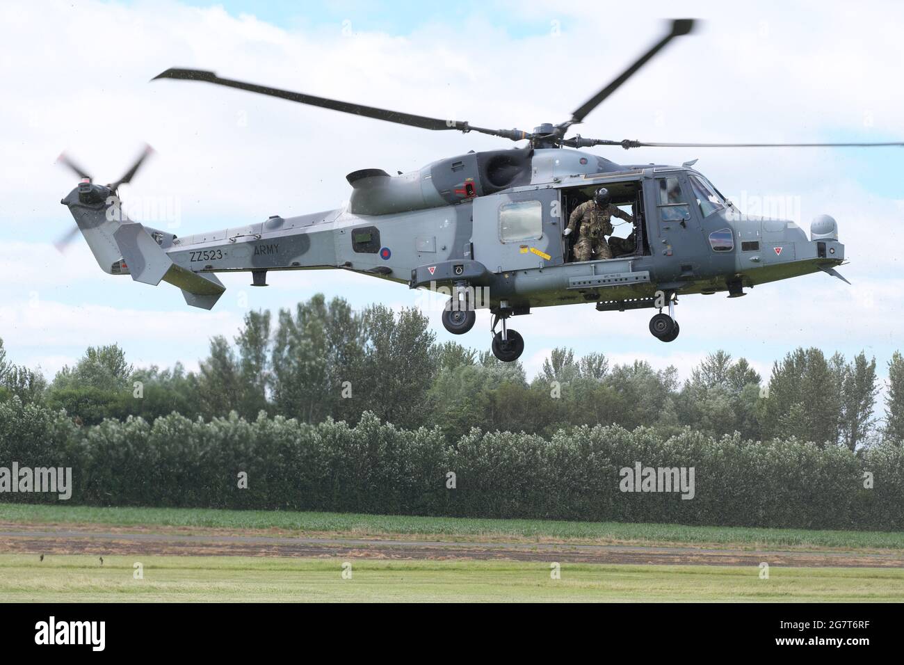 Army Air Corps AgustaWestland Wildcat AH1 helicopter coming into land at a training range in UK July 2021 Stock Photo